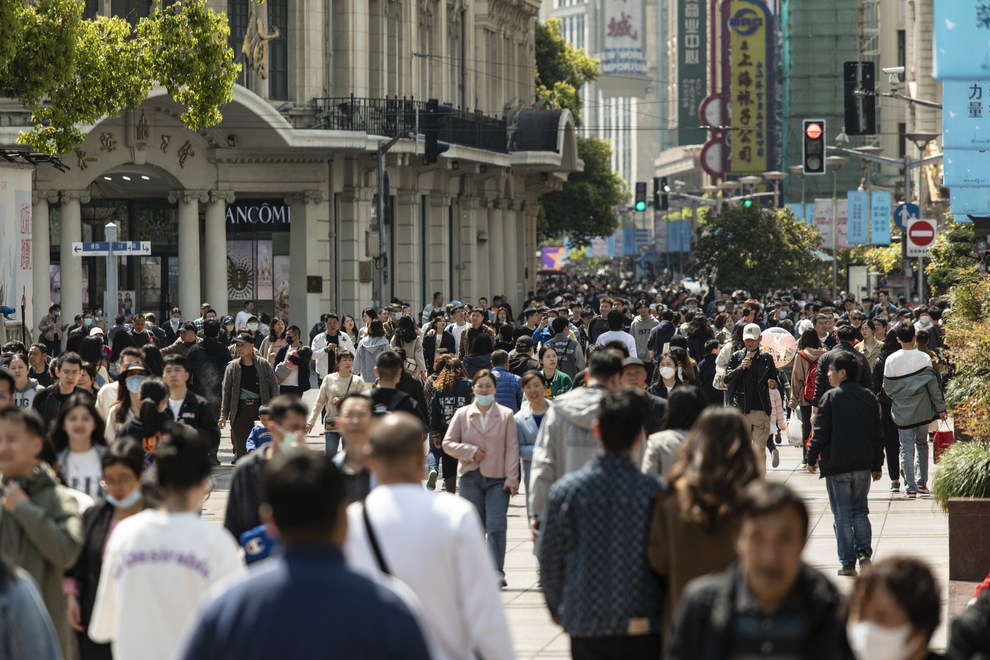 Shoppers walk down Nanjing East Road, one of the city's main commercial and tourist area, in Shanghai, China, on Saturday, April 8, 2023. China is scheduled to release consumer price index (CPI) figures on April 11.