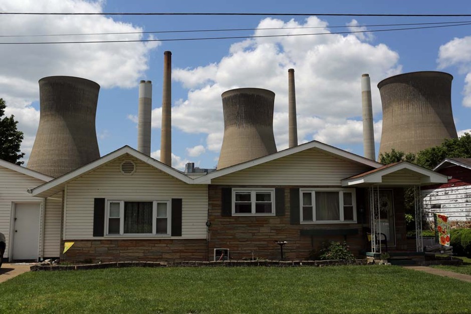 The John Amos coal-fired power plant is seen behind a home in Poca, West Virginia, on May 18, 2014. 