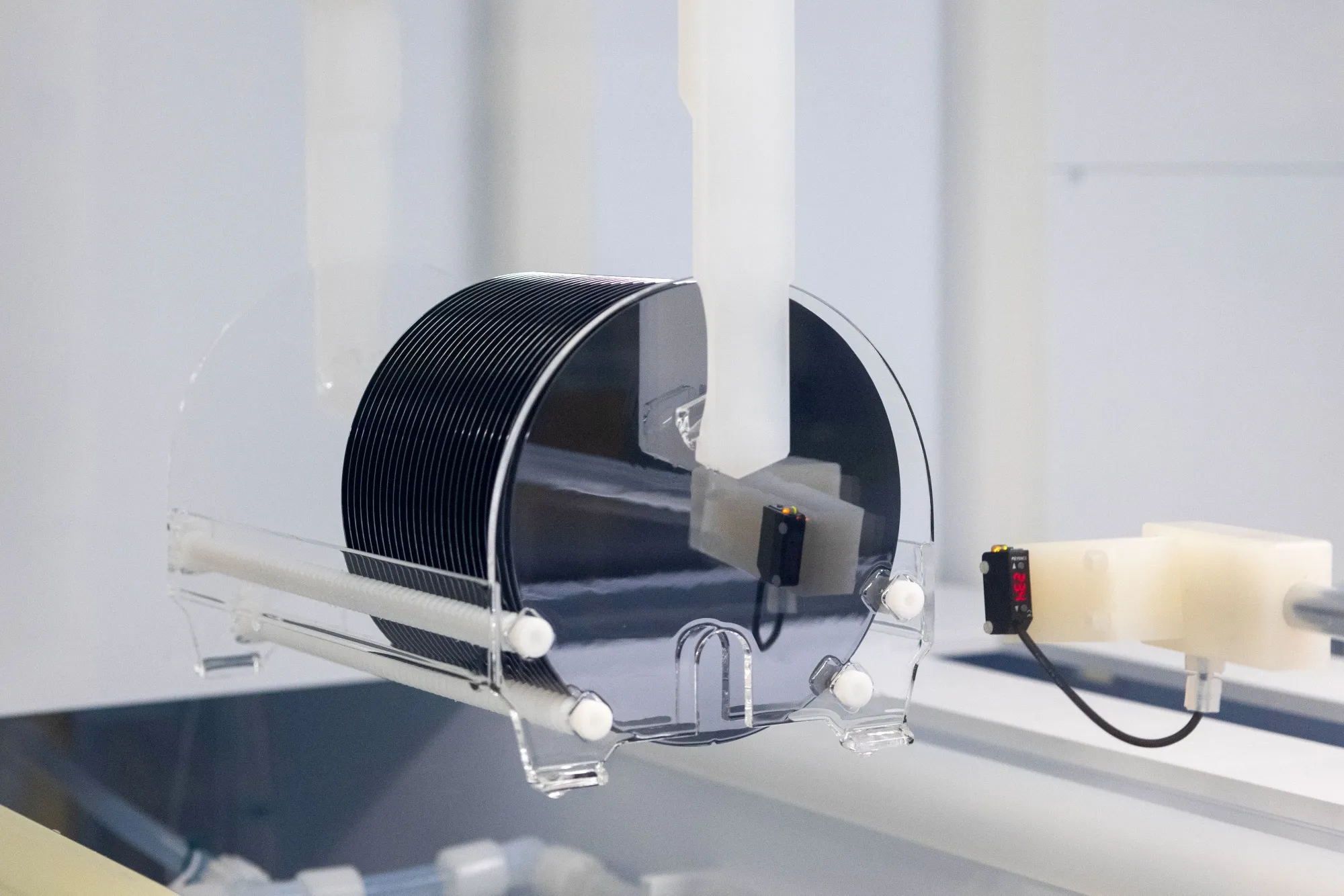 Silicon semiconductor wafers pass through a wet chemical cleaning machine at a&nbsp;Nexperia plant.