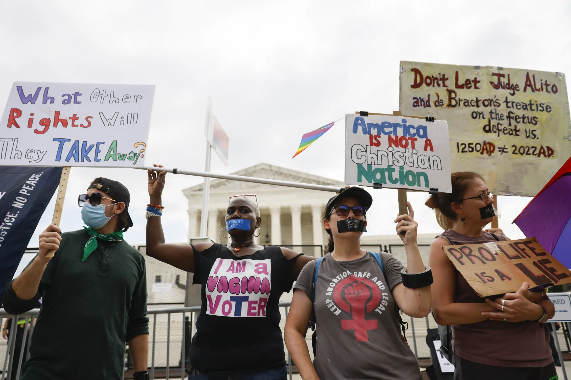 Abortion rights demonstrators hold signs outside the US Supreme Court in Washington, on&nbsp;June 24.&nbsp;