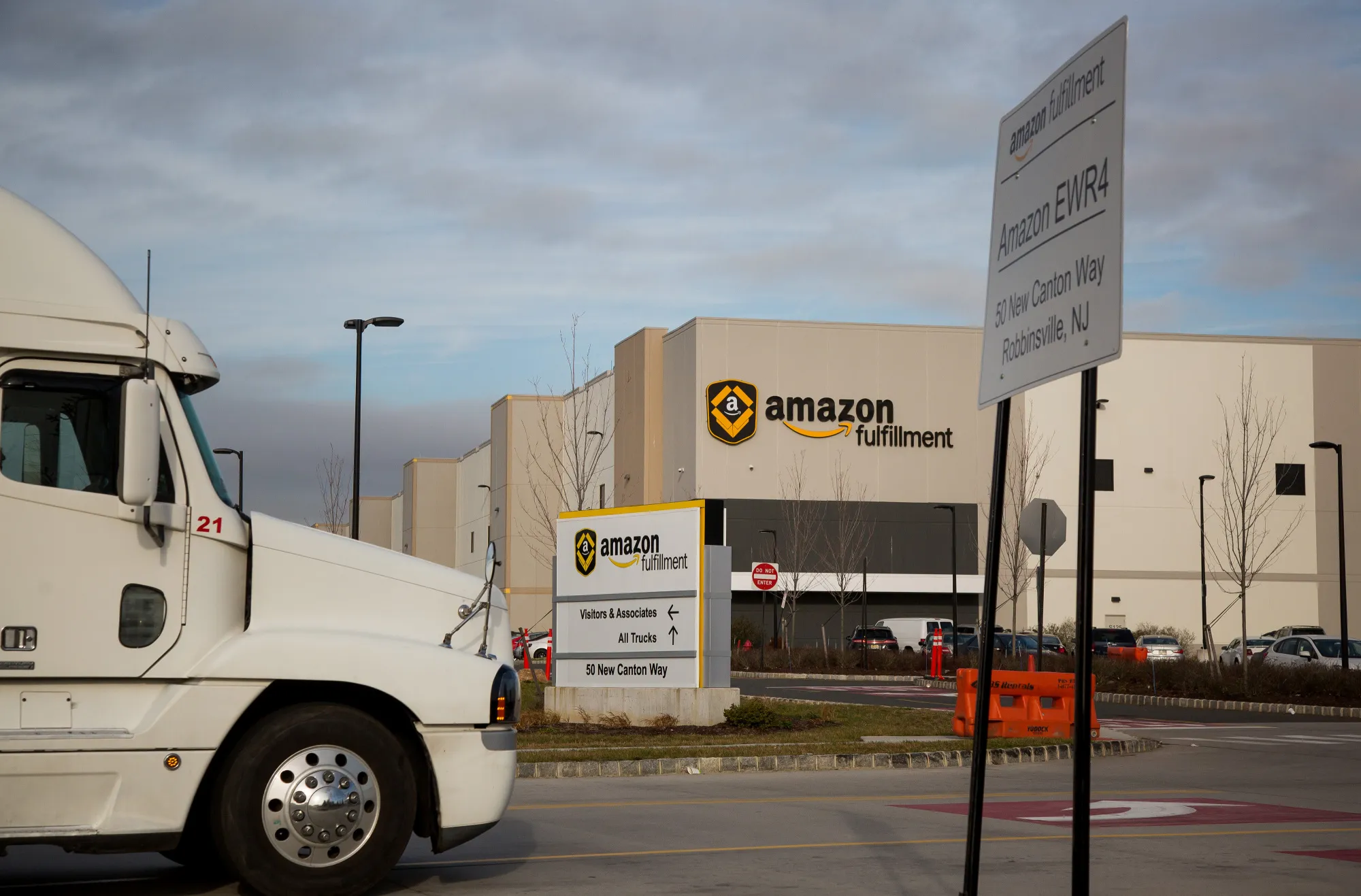 A truck drives past the Amazon.com fulfillment center.
