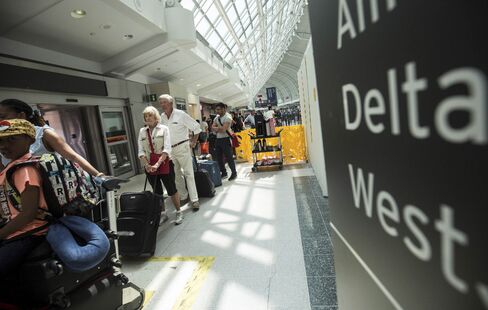 Passengers wait to board a Delta flight