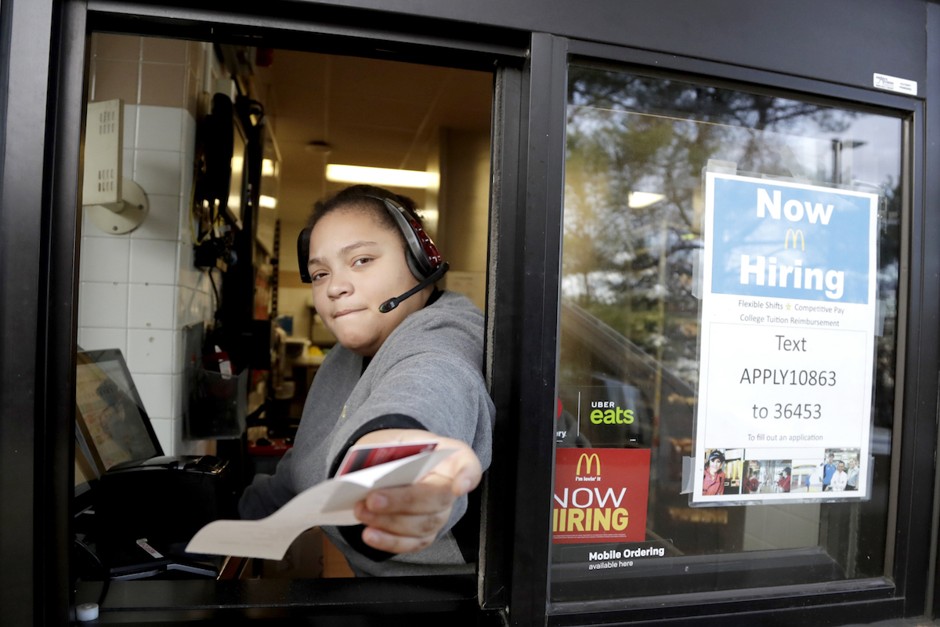 A cashier returns a credit card and a receipt at a McDonald's drive-through window in New Jersey.
