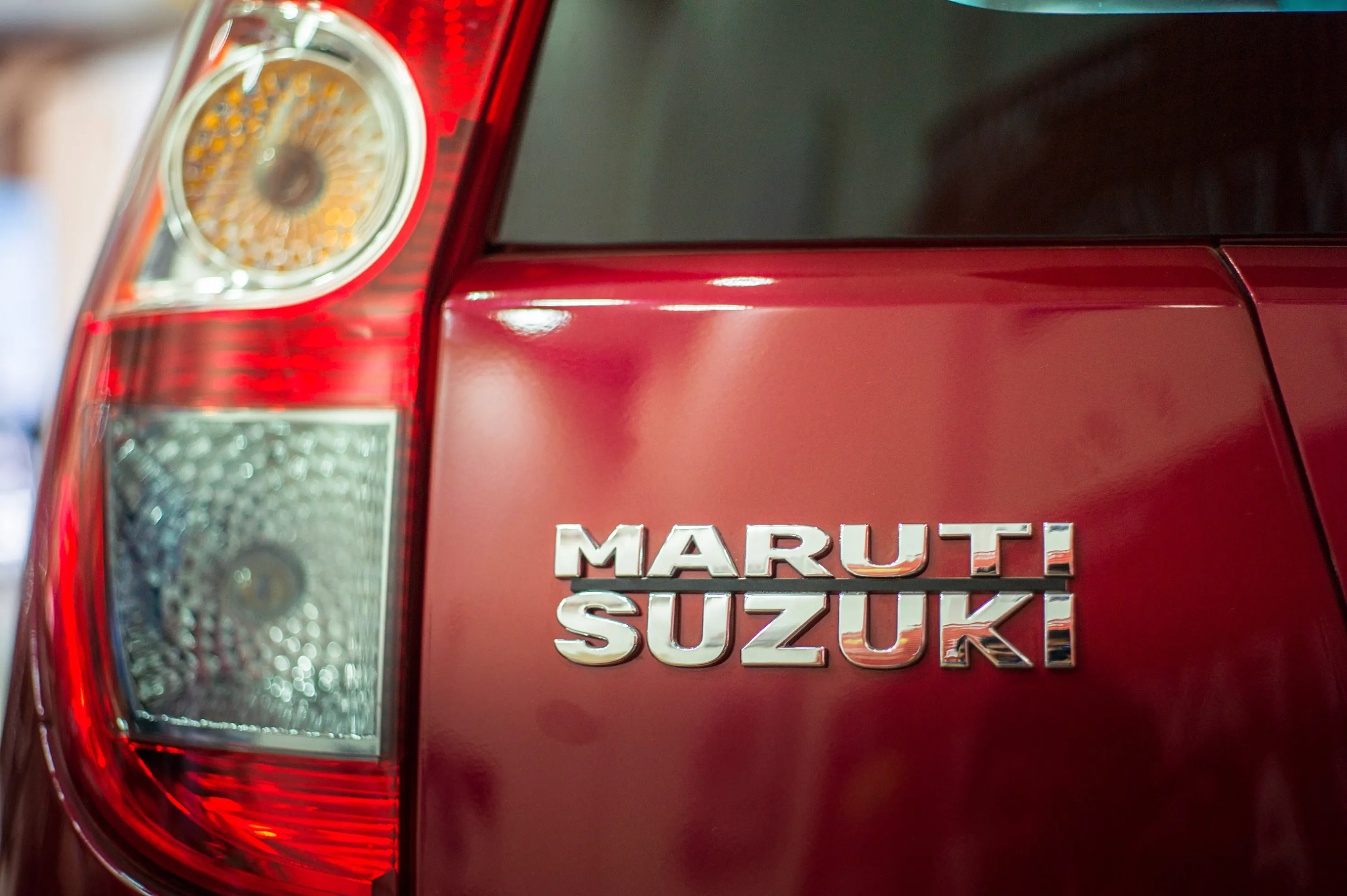 The Maruti Suzuki logo is displayed on a vehicle at a dealership in New Delhi.