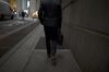 A pedestrian walks along a street near the New York Stock Exchange (NYSE) in New York, U.S., on Monday, Nov. 26, 2018 Beaten-down tech shares led the rebound in U.S. stocks, while Treasuries fell as investors gained confidence from positive political developments in Europe and rising oil prices.