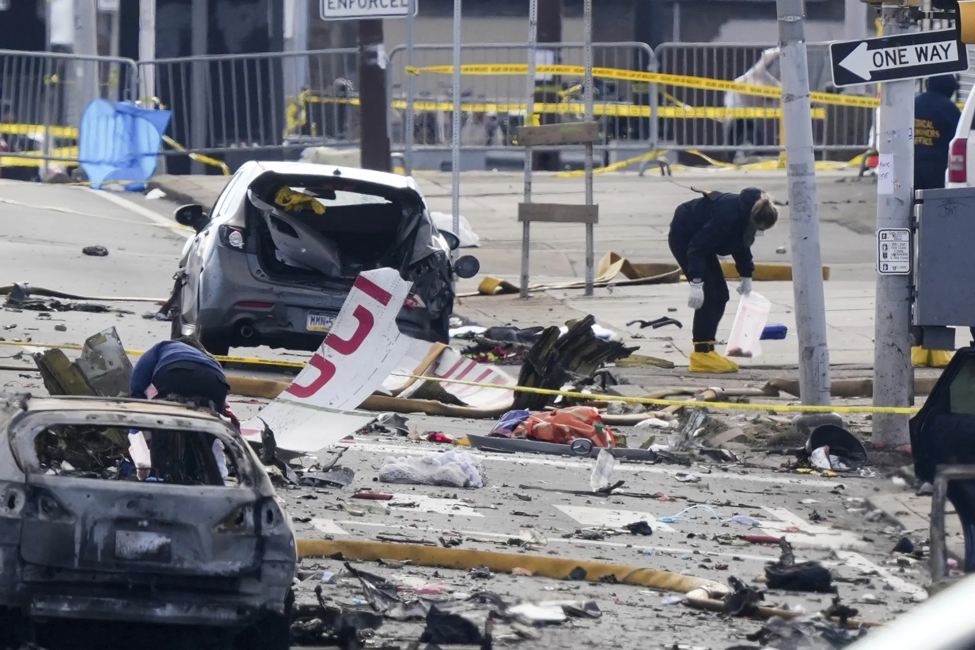 Investigators investigate the scene after a small plane crashed in Philadelphia, Pennsylvania, on Feb. 1.