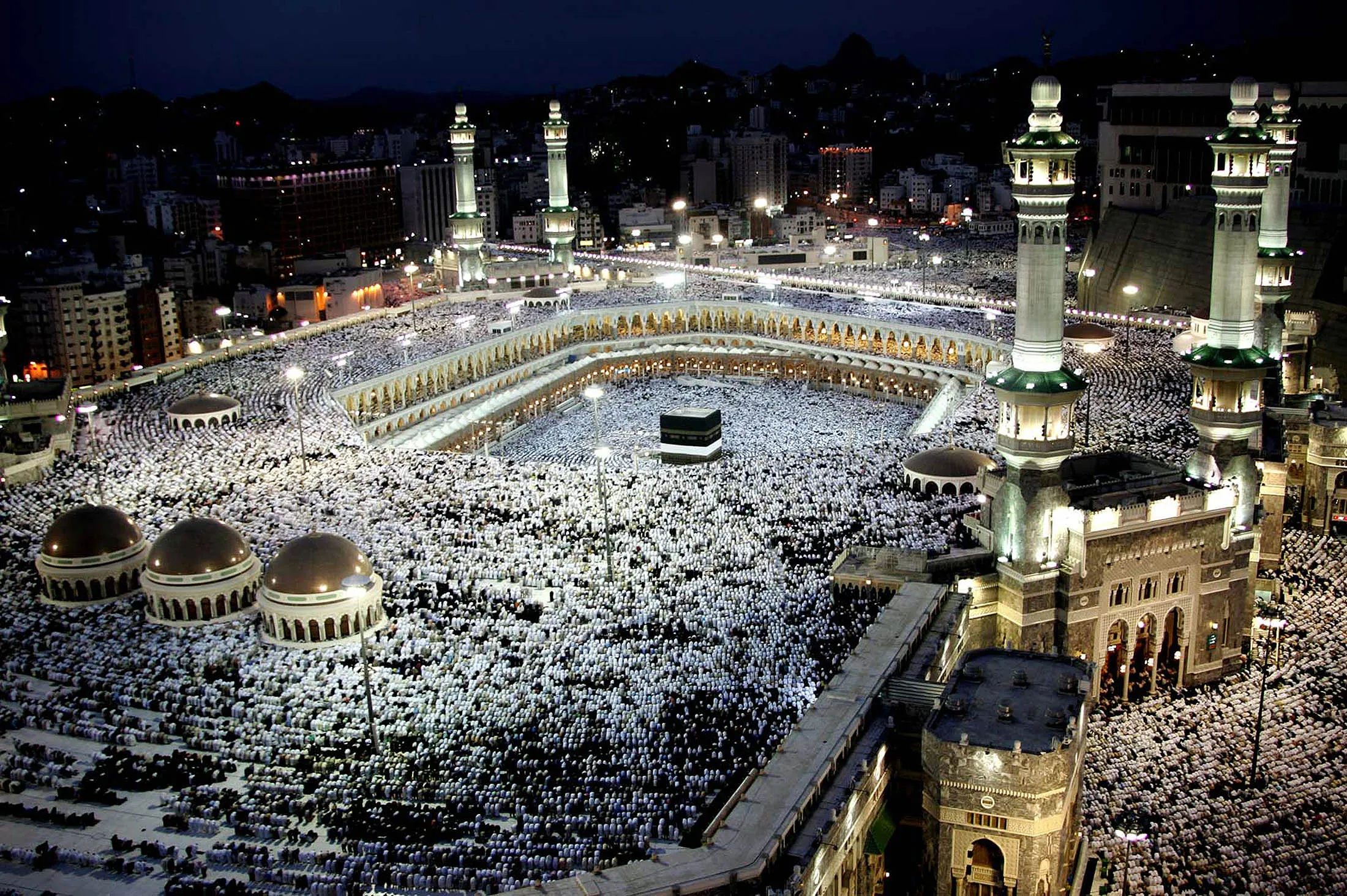 MECCA, SAUDI ARABIA - JANUARY 17: Muslim pilgrims pray at the holy Kaaba at Mecca's Grand Mosque during the annual hajj rituals January 17, 2005 in Mecca, Saudi Arabia. Officials say over 1.6 million worshippers have come from abroad for this year's haj, a once-in-a-lifetime duty for every able-bodied Muslim.
