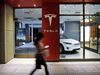 A pedestrian walks past a closed Tesla Inc. store.