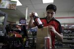 A 7-Eleven employee serves a customer in Santa Monica, California.