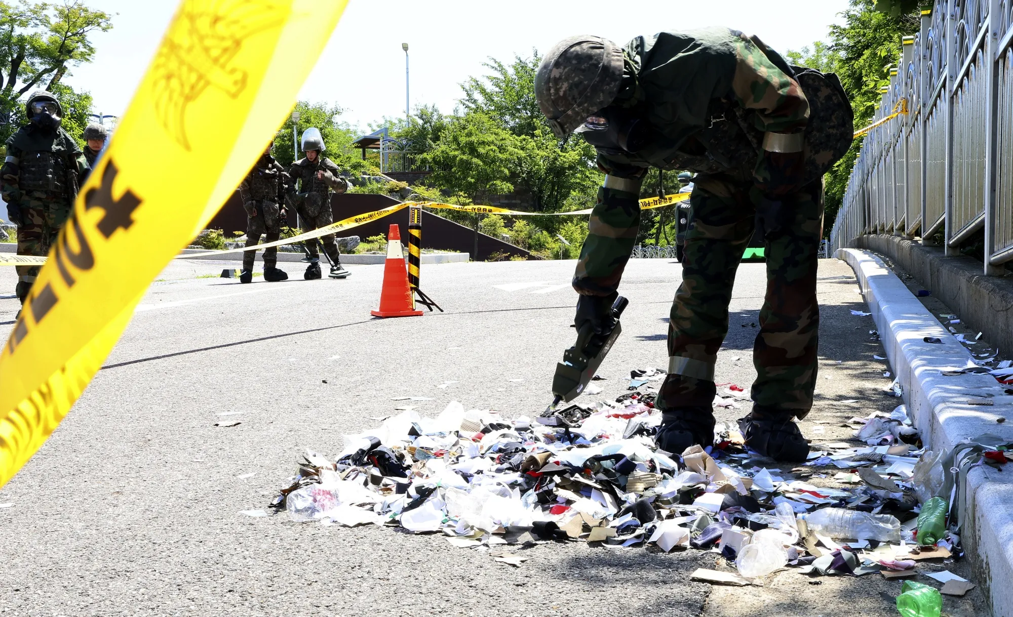 A South Korean soldier checks trash from a balloon sent by North Korea, in Incheon, South Korea, on June 2.