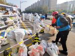 Workers arrange food supplies at a residential complex where residents are under lockdown in Beijing on Nov. 3.