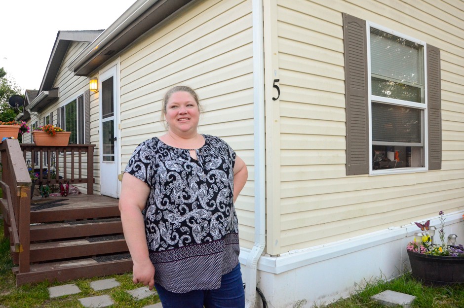 Danelle Knapp stands outside her home at the Duvall Riverside Village, where she has lived for five years.