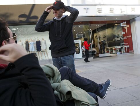 Tesla enthusiasts in Santa Monica, California, wait overnight to join the queue for the Model 3.