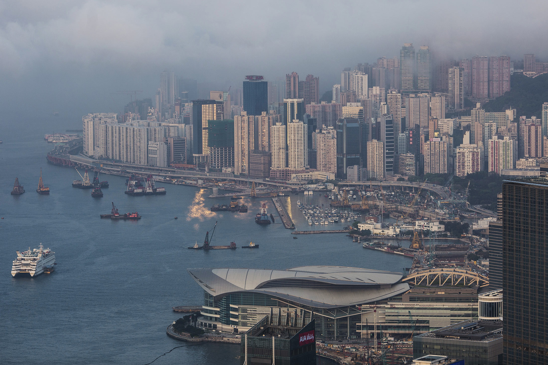 The Hong Kong Convention and Exhibition Centre, center bottom, and other buildings stand in Hong Kong, China, on Wednesday, April 6, 2016. Cash is pouring into Hong Kong stocks from across the mainland border.
