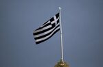 A Greek flag flies.
