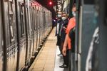 Commuters wait on the platform at the Times Square subway station in New York on Wednesday, May 25, 2022. Weekday ridership on the subway is about 60% of pre-pandemic levels.