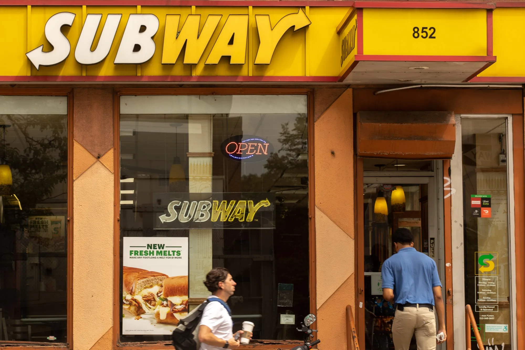 A customer enters a Subway Restaurant in New York.