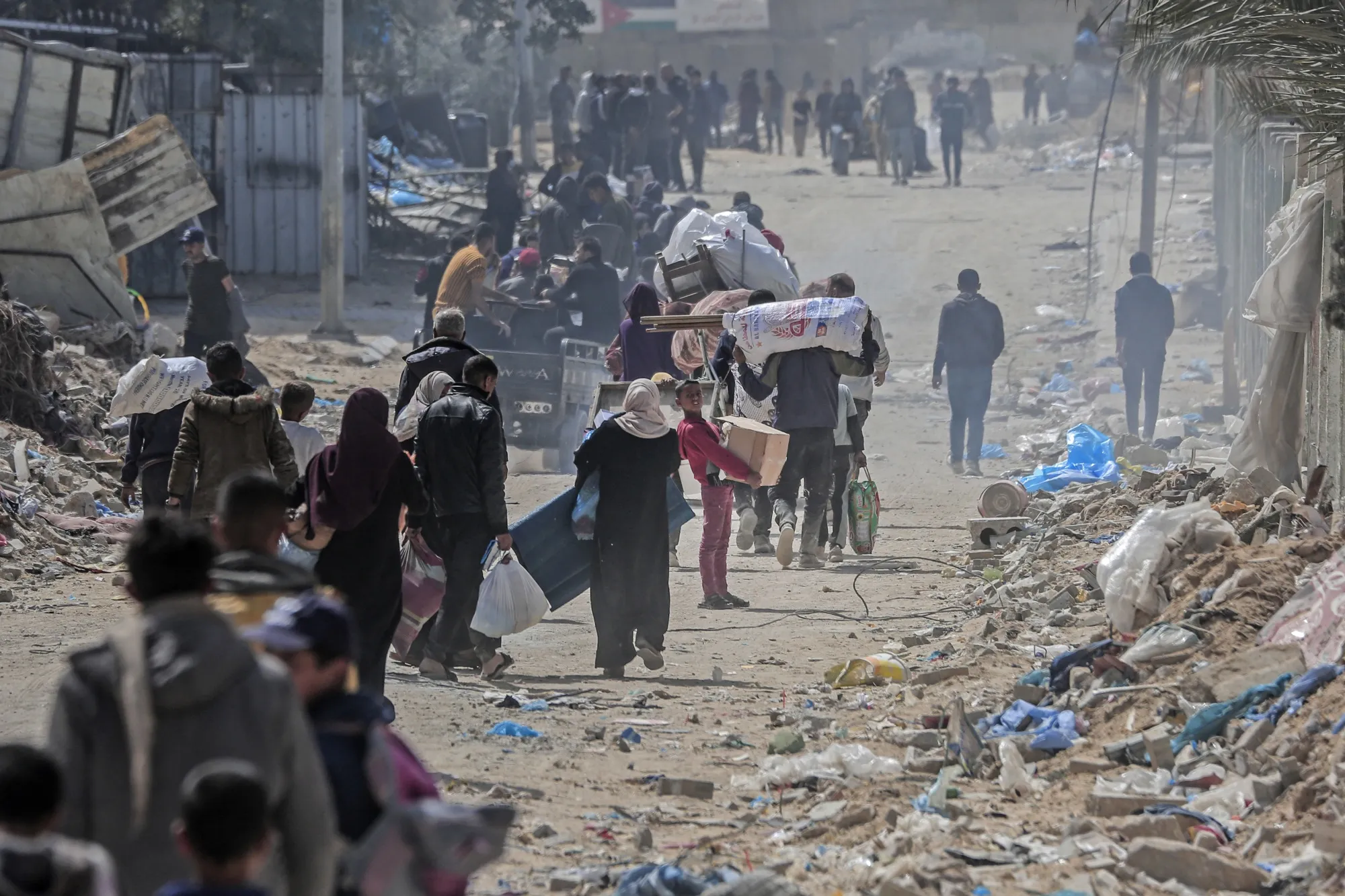 Displaced peoples&nbsp;carry belongings through&nbsp;Khan Yunis in Gaza on March 6.