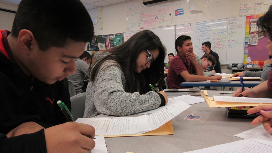 8th graders at Emiliano Zapata Academy pen down letters to kids at Amundsen High School.
