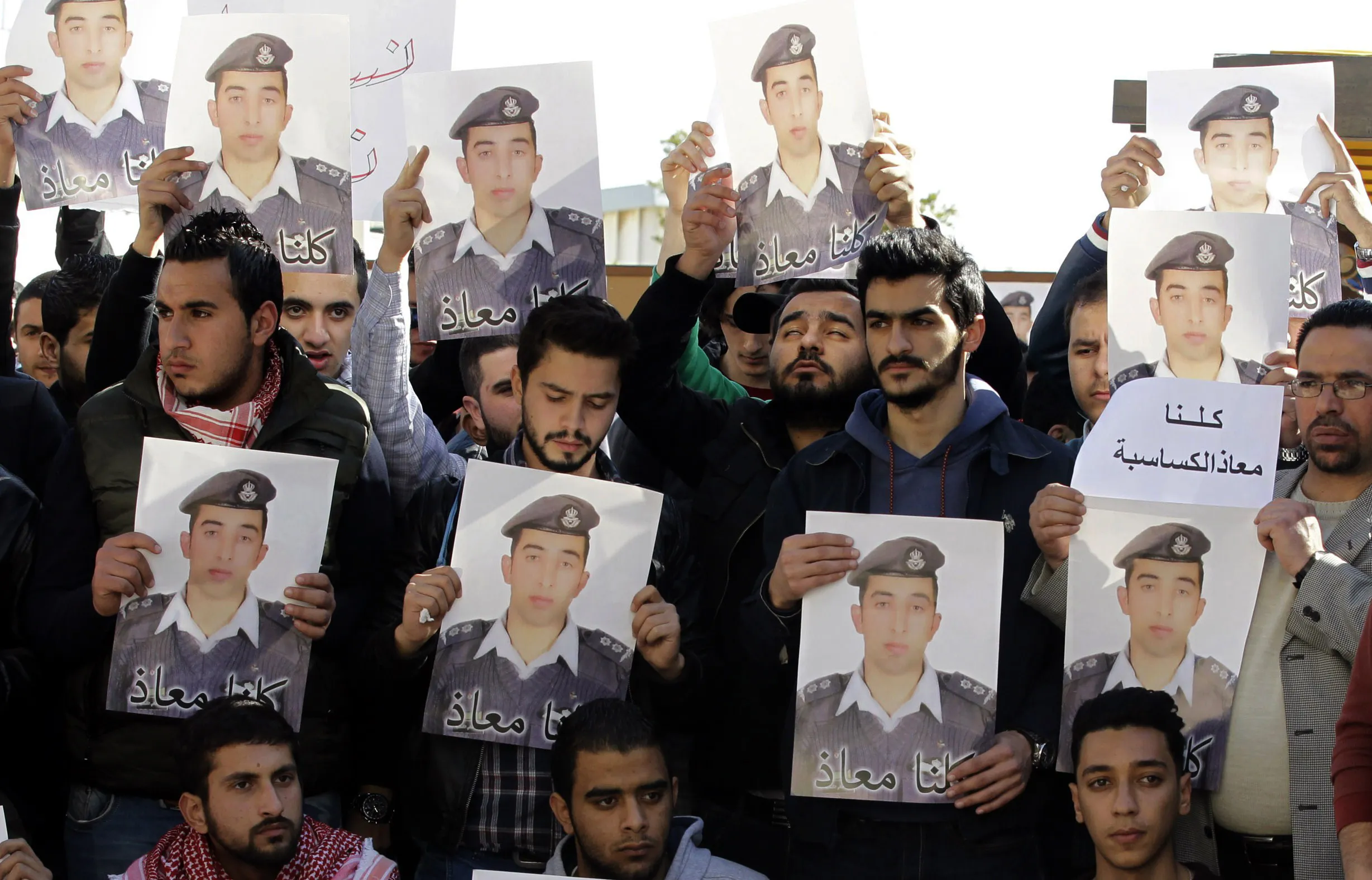 Activists carry posters with a portrait of the Jordanian pilot Maaz al-Kassasbeh, who was captured by Islamic State (IS) group militants on Dec. 24 after his F-16 jet crashed while on a mission against the jihadists over northern Syria, during a rally in the Jordanian capital Amman on Feb. 3, 2015.
