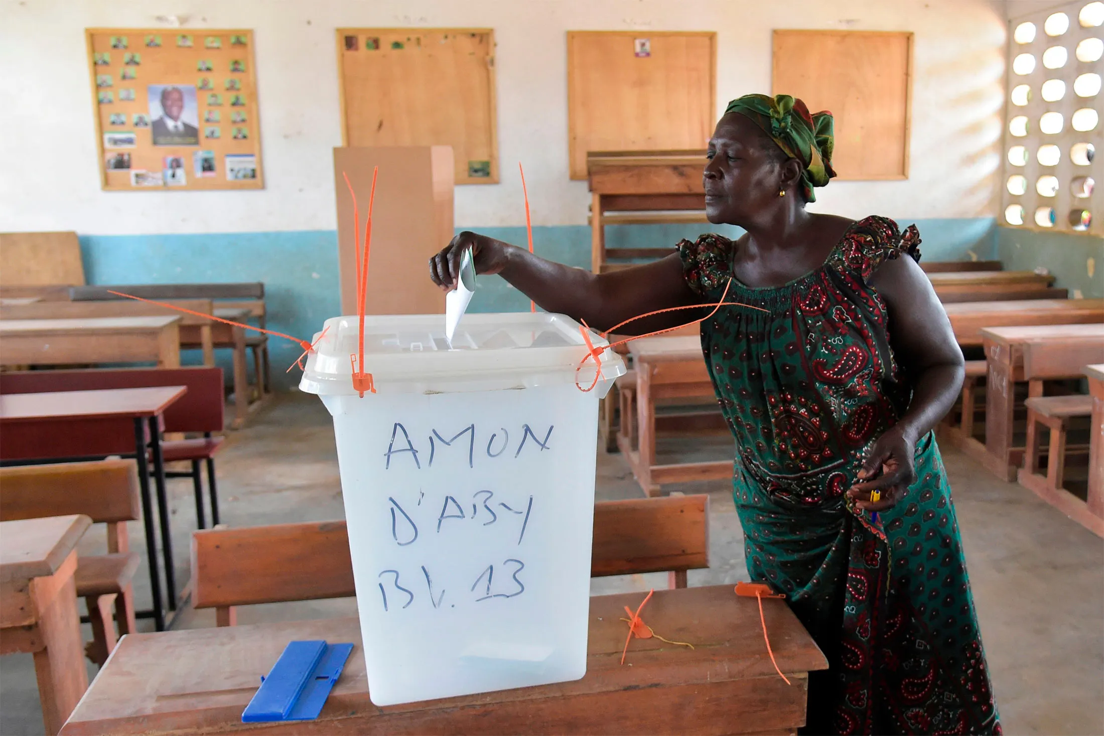 A woman cats her vote in Ivory Coast's regional and municipal elections at a polling station in Abidjan's central business district of Plateau on Oct. 13, 2018. (