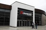 Pedestrians pass a Cineworld cinema in Aldershot, UK.