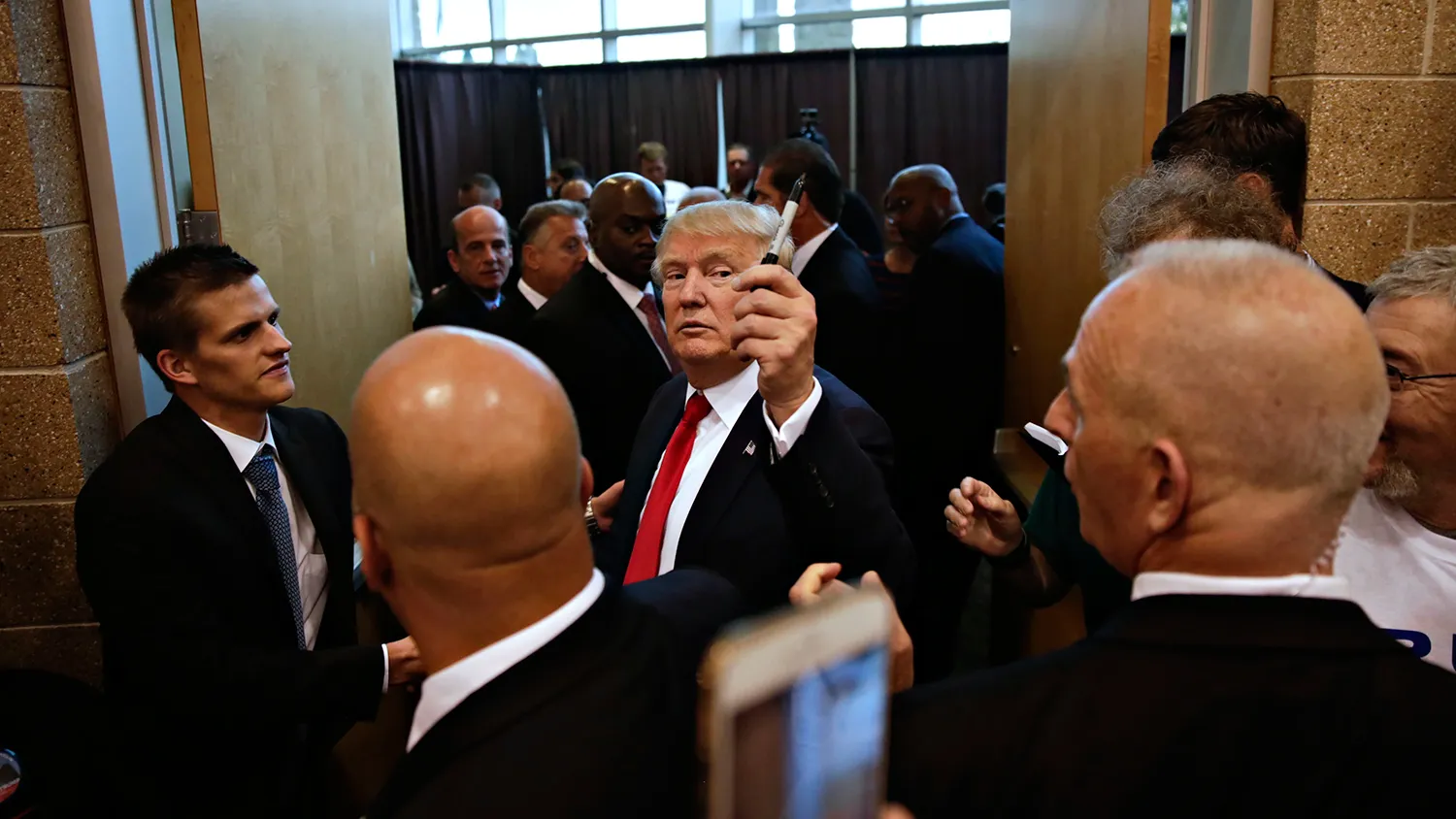 Donald Trump, president and chief executive of Trump Organization Inc. and 2016 Republican presidential candidate, leaves after speaking during a rally at Grand River Center in Dubuque, Iowa, U.S., on Tuesday, Aug. 25, 2015.
