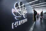 A Huawei Technologies Co. logo sits on display as customers browse inside a Media Markt electronic goods store, operated by Ceconomy AG, in Berlin, Germany, on Monday, Dec. 17, 2018. Ceconomy announce full year earnings figures on Dec. 19.