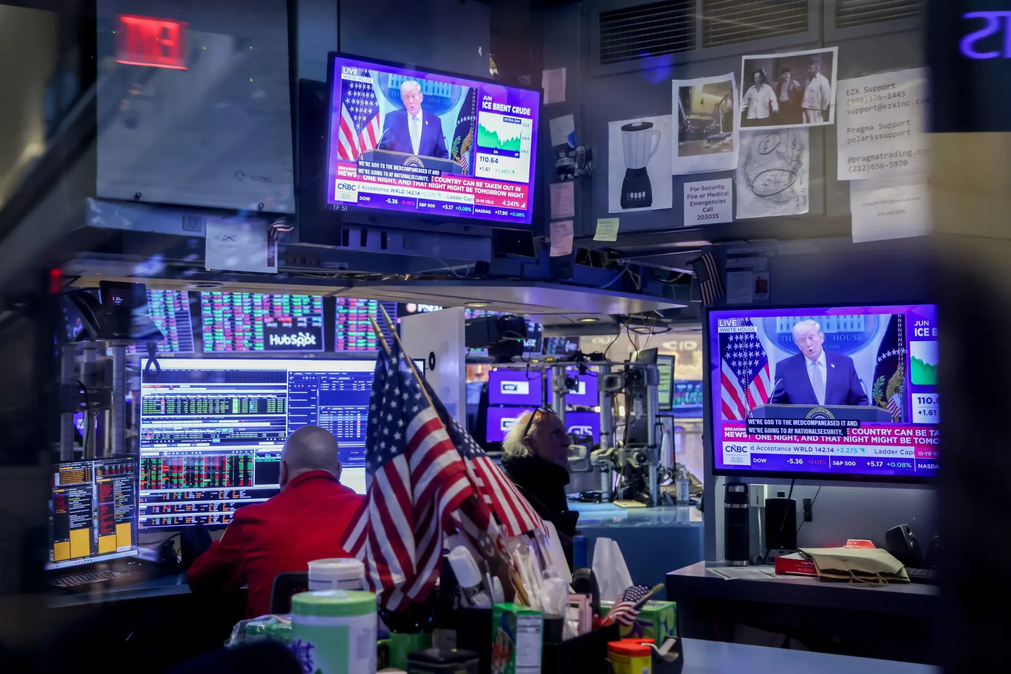 A television station broadcasts a news conference with US President Donald Trump on the floor of the New York Stock Exchange.
