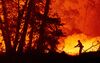 A firefighter douses flames during the Creek fire in the Cascadel Woods area of California on Sept. 7.