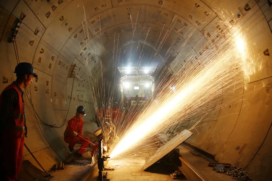 Workers cut rail tracks at the construction site of Changzhou's first subway line, set to open in 2019.