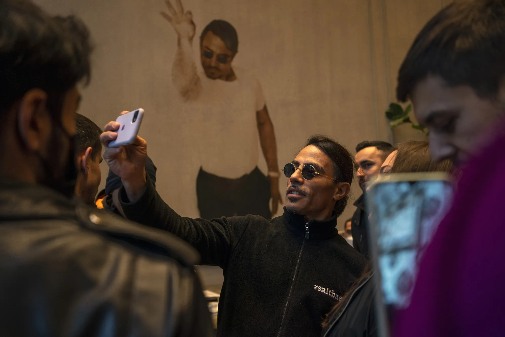 Salt Bae takes a selfie photo with customers in his restaurant in Istanbul, Turkey.