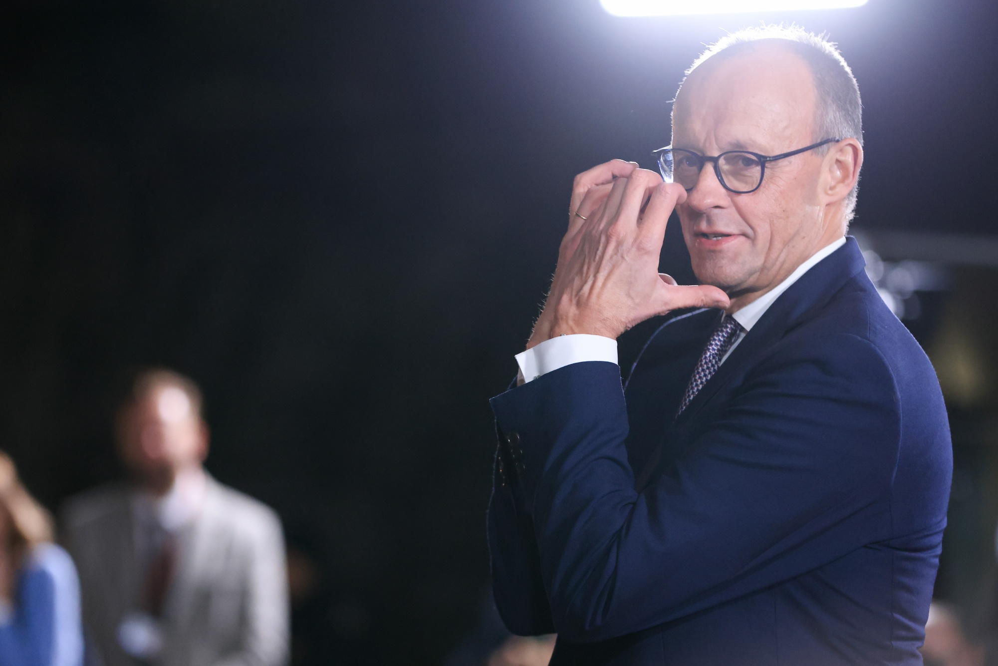 Friedrich Merz, Germany's chancellor, waits to greet attends at a Ukraine peace summit at the Chancellery in Berlin, Germany, on Monday, Dec. 15, 2025. European officials are growing concerned that an emerging US-brokered peace deal in Ukraine could be exploited by Russia, paving the way for a re-invasion of territory in the war-battered nation's eastern Donbas region. Photographer: Krisztian Bocsi/Bloomberg