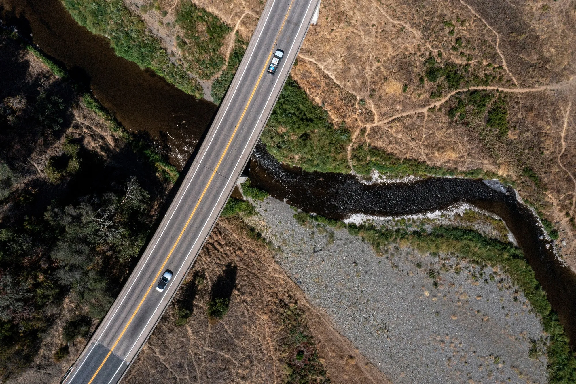 Traffic on Highway 20 over the East Fork Russian River during a drought in Mendocino County, California.