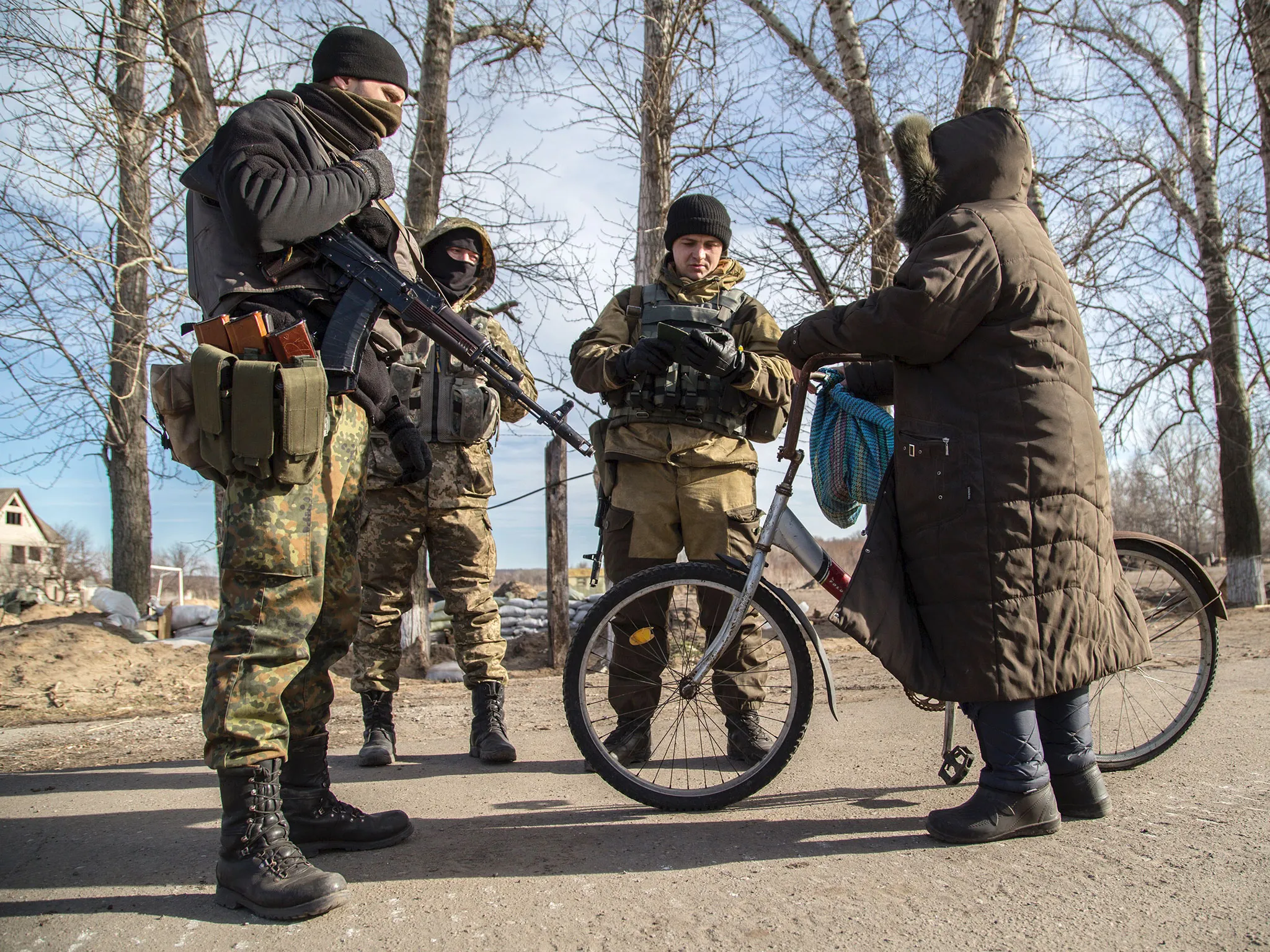 Ukrainian servicemen check documents of a local resident at a checkpoint near Slavyanoserbsk, in the region of Lugansk on Feb. 25, 2015.
