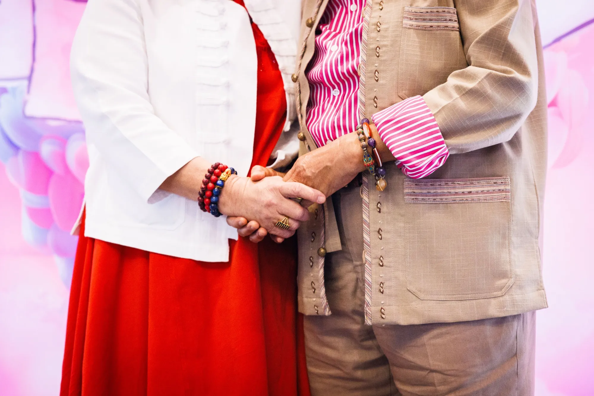 A couple hold hands during a symbolic mass wedding for LGBTQ+ in Bangkok, on Feb. 14.