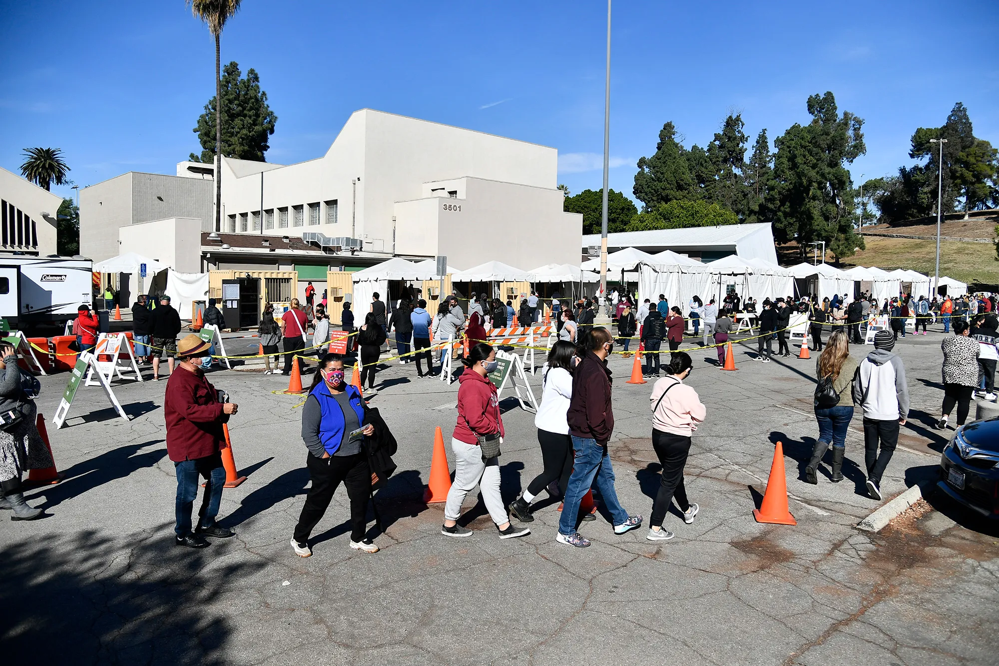 People wait in line at a Coronavirus testing and vaccination site in Los Angeles.