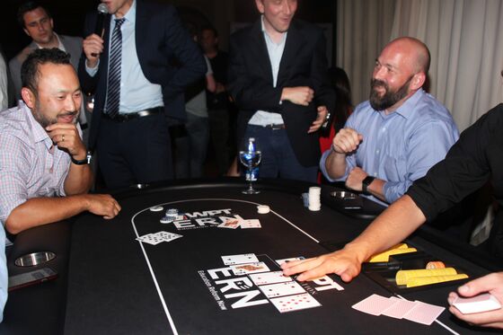 Derivatives Trader Hits a Full House for Charity Poker Crown