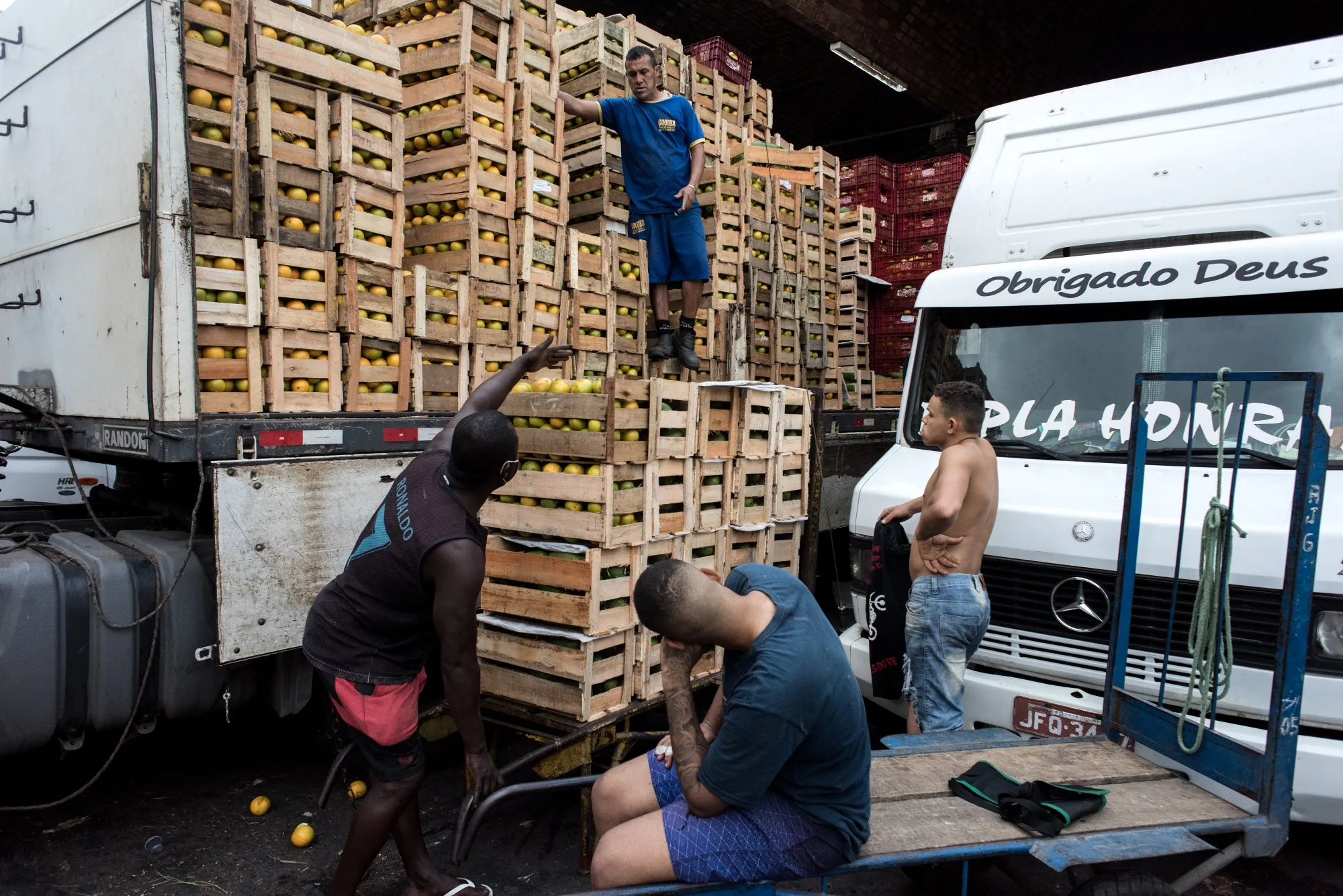 Workers move crates of fresh food at the CEASA market and distribution center in Rio de Janeiro.