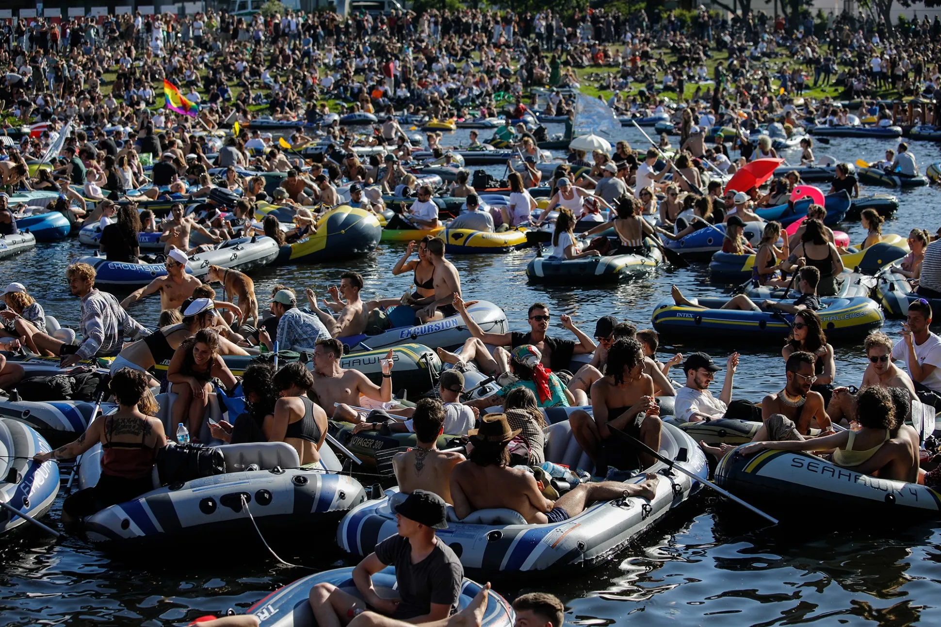 People attend a dance music event on the Landwehr canal in Berlin, on May 31