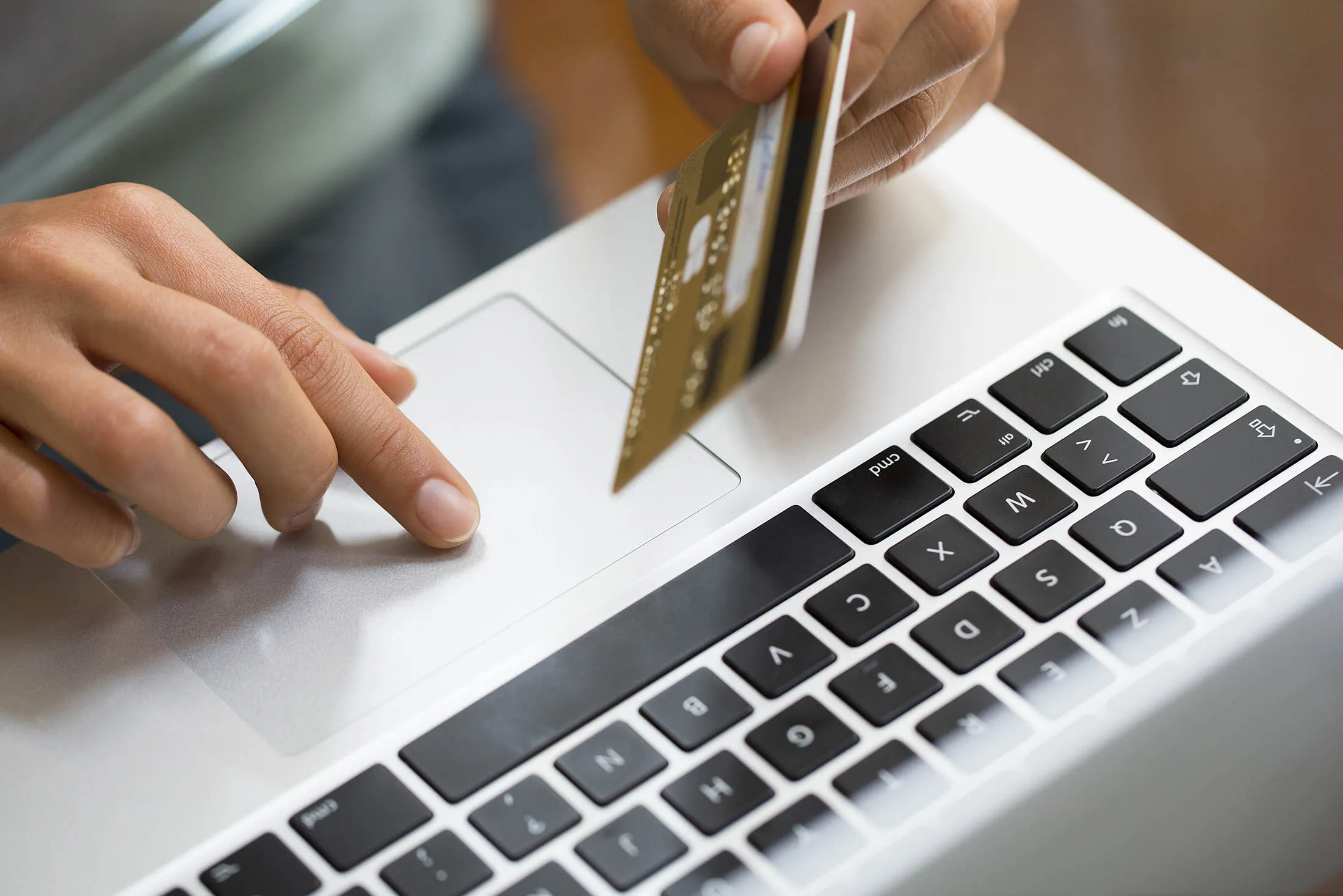 Close-up hand woman using laptop and credit card, online shopping