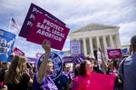 Pro-choice activists holds signs during a rally in front of the U.S. Supreme Court in Washington.