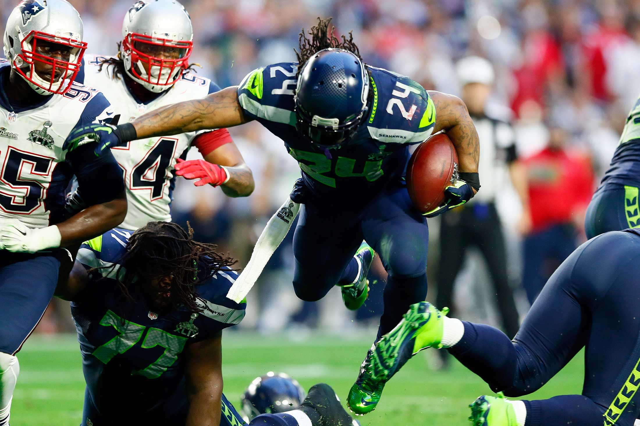 Running back Marshawn Lynch #24 of the Seattle Seahawks runs the ball against the New England Patriots during Super Bowl XLIX at University of Phoenix Stadium on Feb. 1, 2015 in Glendale, Ariz.
