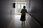 A woman, suffering from Alzheimer's desease, walks in a corridor on March 18, 2011 in a retirement house in Angervilliers, eastern France. AFP PHOTO / SEBASTIEN BOZON (Photo credit should read SEBASTIEN BOZON/AFP/Getty Images)