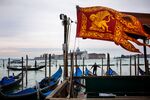 The Standard of Saint Mark, the flag of the Venetian region, flies next to gondolas in Piazza San Marco&nbsp;in 2019. Heavily dependent on tourism, Venice&nbsp;is eager to attract young professionals who want to live in, not just visit, the historic city.&nbsp;
