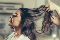 Cropped Image Of Hairdresser Holding Customer Hair In Salon