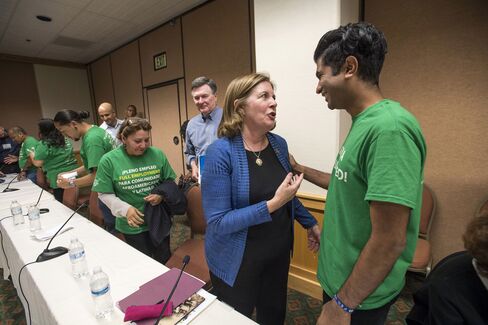Esther George speaks with Shawn Sebastian, field director of the pro-worker Fed Up coalition, an initiative of the Center for Popular Democracy, following a meeting with a coalition of activists on the sidelines of the Jackson Hole economic symposium on Aug. 25.