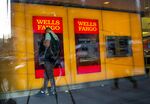 A man uses a Wells Fargo & Co. automated teller machine (ATM) inside a bank branch in New York, U.S., on Tuesday, July 12, 2016. Wells Fargo & Co. is scheduled to release earnings figures on July 15.