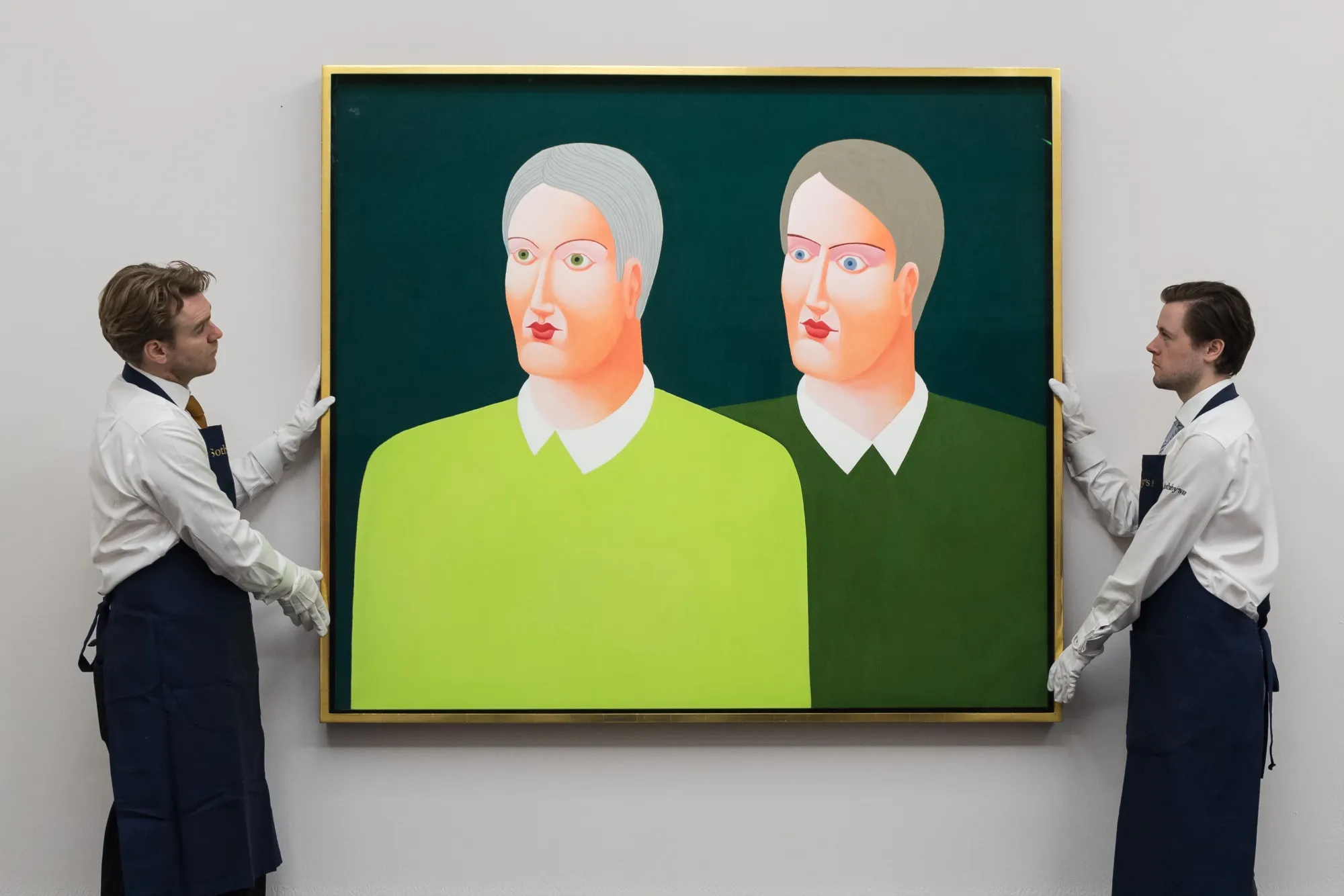 Art handlers hold a painting by Nicolas Party: "Portraits".