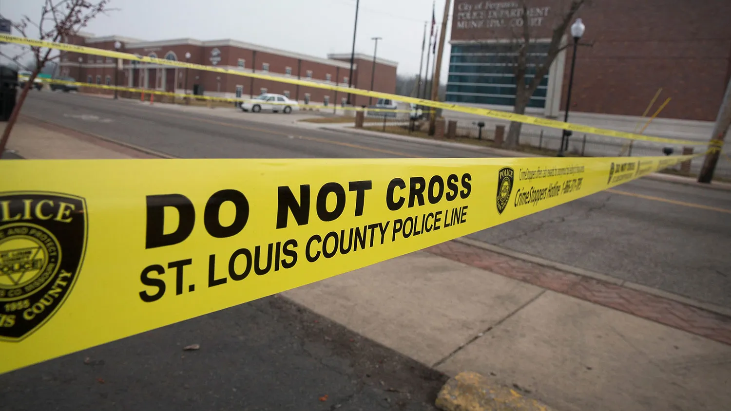 Law enforcement officials secure the crime scene and continue to search for evidence outside the police station after two officers were shot and wounded during last night's protest on March 12, 2015 in Ferguson, Missouri.
